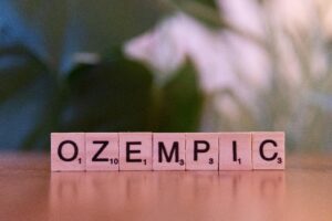 a collection of letter tiles that spells ozempic. Fake glp-1 drugs seek to cash in on the demand for drugs like ozempic and wegovy